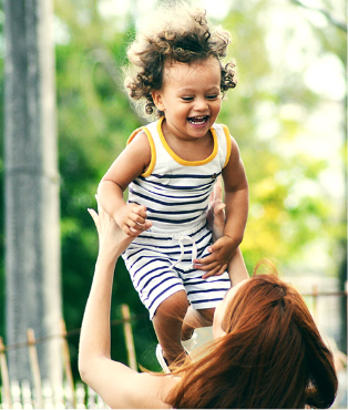 mother carrying child up in the air with life insurance coverage from Dundas Life