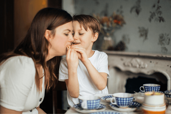 Mother being fed by hand from her son