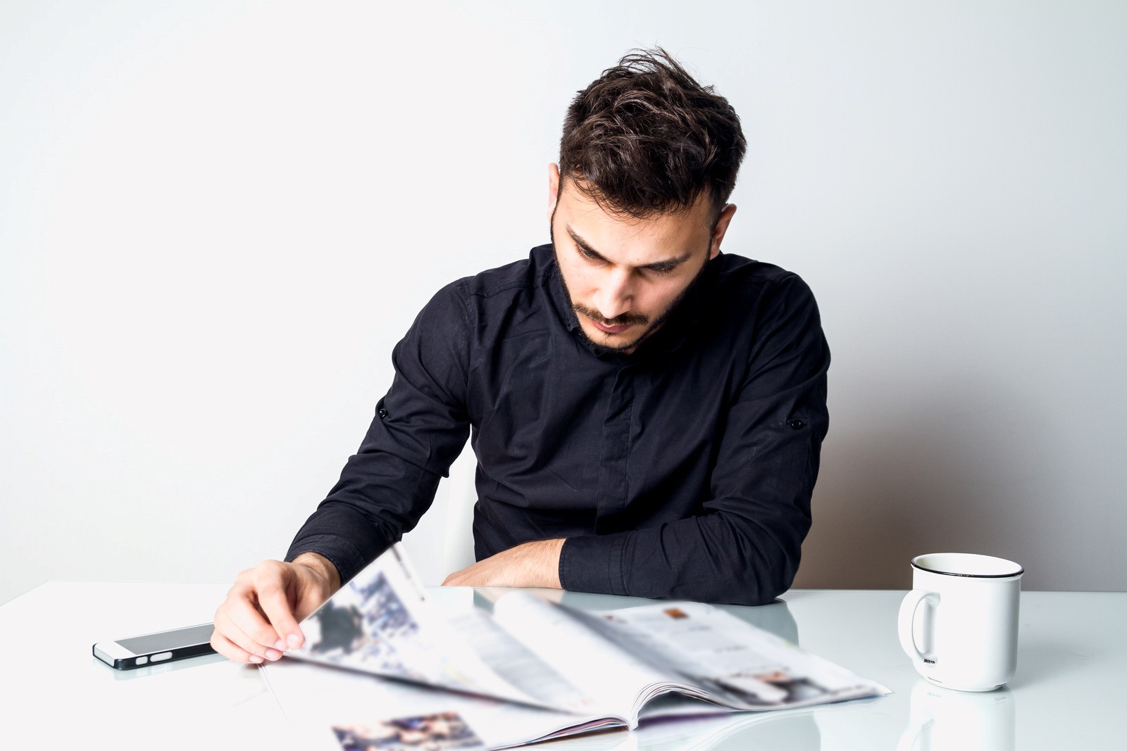 man reading papers to decide if life insurance is worth it