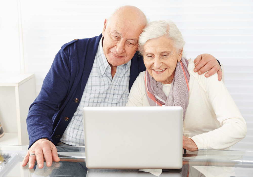 Elderly Couple comparing different types of life insurance on their laptop