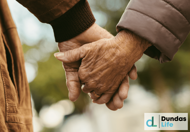 Elderly Couple Holding Hands and Walking