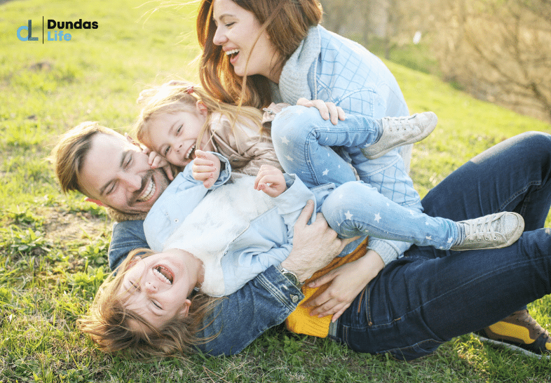 Happy family in the outdoors playing on the grass.