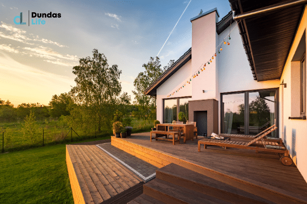 A Beautifull backyard of a house as the sun is setting.