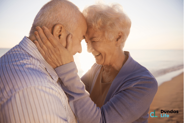 Two seniors at the beach happy.