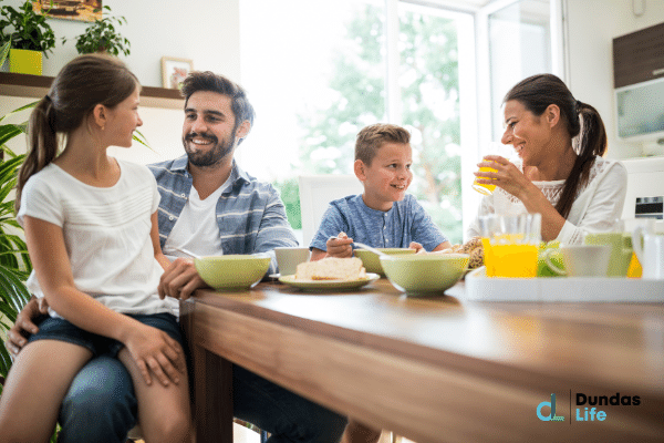 Happy family having breakfast together after buying life insurance.